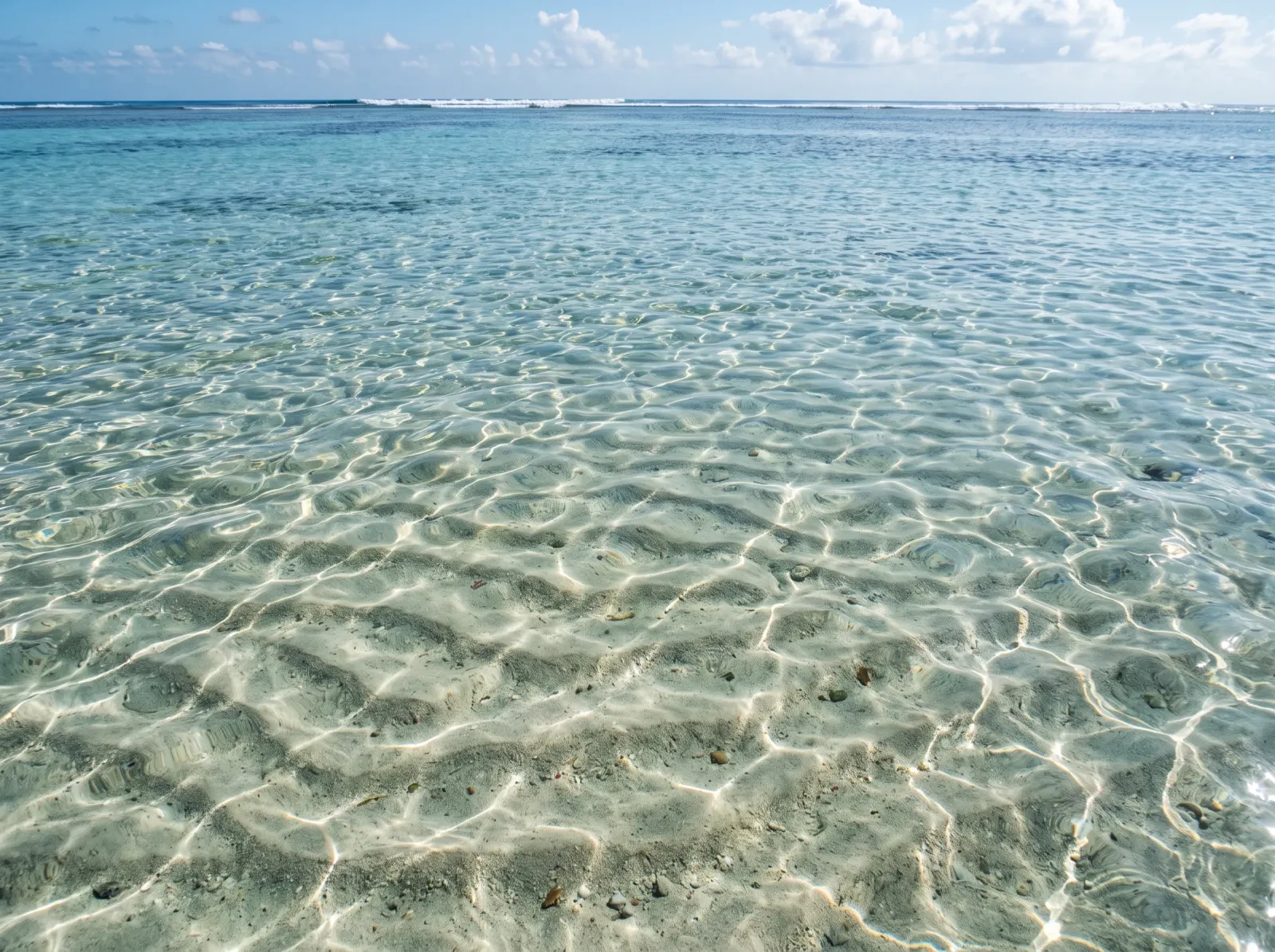 Clear shallow sea water over rippled sand